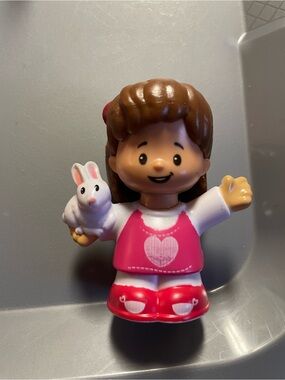 Fisher-Price Little People Mia Girl Figure in Pink Outfit with White Bunny